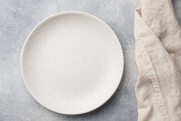 Empty plate on cement background. Top view with copy space