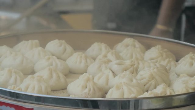 Traditional steamed chinese dumpling while cooking