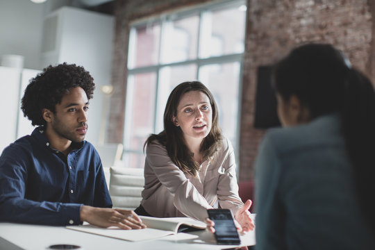 Business people talking with colleague in meeting