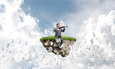 Handsome violinist play his melody and letters fly around in air