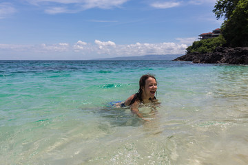 Obraz premium Happy girl swimming in the blue sea