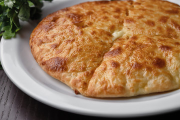 Megrelian Khachapuri, on a white plate. Traditional Georgian cuisine
