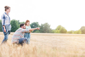 Family enjoying on farmland against sky