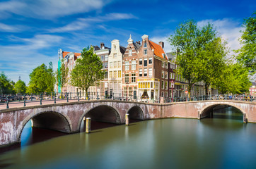 Canal with traditional buildings in Amsterdam, Netherlands - obrazy, fototapety, plakaty