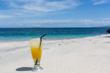 Mojito cocktail drink with evening sunset on beach background