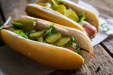 Hot dog with greens and pickled cucumbers