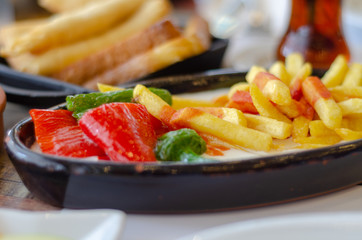 Fried potato,pepper, borek  and turkish tea on the table.