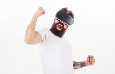 Guy with head mounted display interact virtual reality. Hipster play virtual game. Virtual victory. Man bearded gamer VR glasses white background. Cyber reality game concept. Win virtual contest