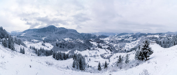 Fototapeta na wymiar Village near the mountain during winter time