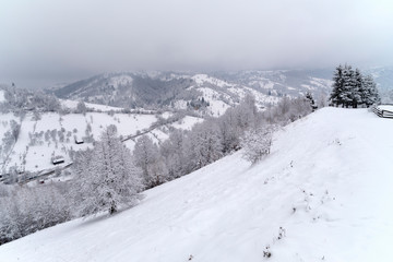 Fototapeta premium Village near the mountain during winter time