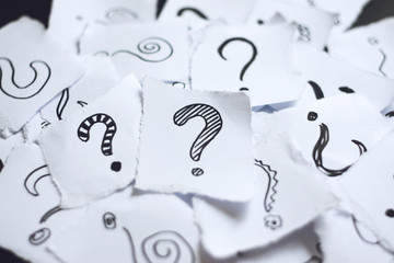 Many question marks on white papers. Doodle drawn question marks on scraps of paper. Choice,...