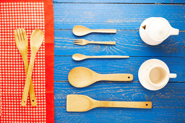 Wooden spoon and fork on blue wood table background