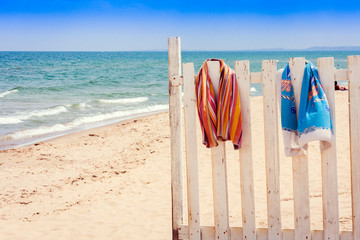 Fence with beach towels on the beach of Catania, Sicily, Italy.