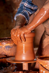 Professional potter making bowl in pottery workshop, studio.