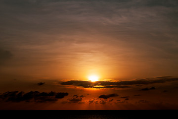 Fototapeta na wymiar Beautiful sunset on the sea dramatic light and clouds