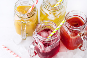 Fototapeta na wymiar Variety of Tasty Juices in Glass Jars Mugs Healthy Beverages Drinks White Background Horizontal