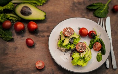 toast with fresh salad, avocado and cherry tomatos
