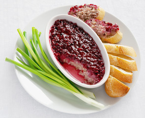 rabbit rillettes with cranberry confiture dish, sliced white bread, and green onion feathers