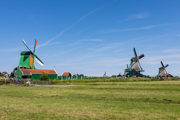 green meadows and old windmills in Zaanse Schans, Netherlands, Europe