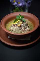 Azerbaijani Kufta bozbash, in pottery, on a dark background