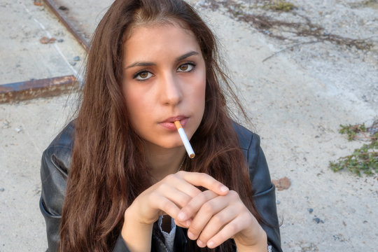 Una ragazza con la sigaretta spenta in bocca