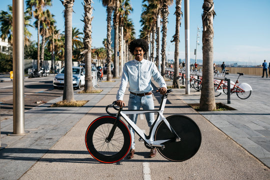 Mid adult man standing on the road, showing his fixie bike
