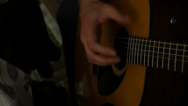 man plays with inspiration on a seven-stringed guitar. 4K
