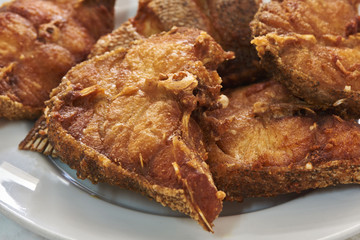 Pieces of delicious fried grouper fish on a white dish