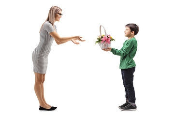Young boy giving flowers to his mother
