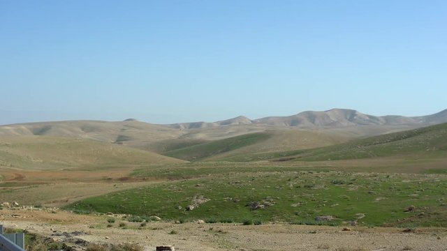 Maale Adumim, israel. car pass by, pan right to desert mountain view