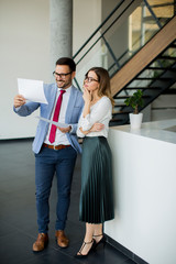 Young business people analyzing documents