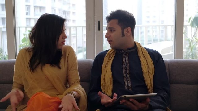 Groom pleads with his bride over something using a communication device he gets angry, she ignores and they finally makeup 