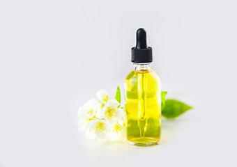 Essence of flowers on white background in beautiful glass jar