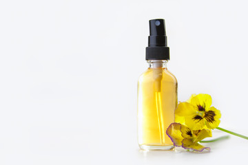 pansies essential oil in  beautiful bottle on  White background