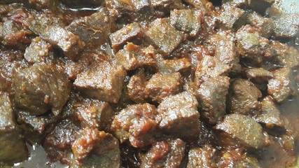 A close up view of Stewed chicken liver withspices  on it
