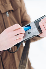 male preparing a rifle for shooting. close up cropped photo. tool for hunting
