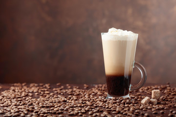 Coffee drink or cocktail with cream and pieces of brown sugar.