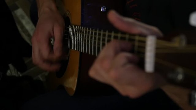 man plays with inspiration on a seven-stringed guitar. slow motion