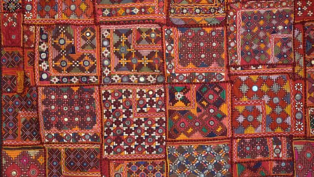 Detail old colorful patchwork carpet, establishing shot. Close up