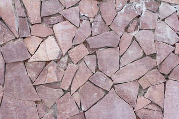 Stone wall, the texture of the outer wall, decorated with decorative stone of various shapes, mosaic