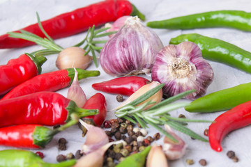hot peppers with spices on wooden table close up