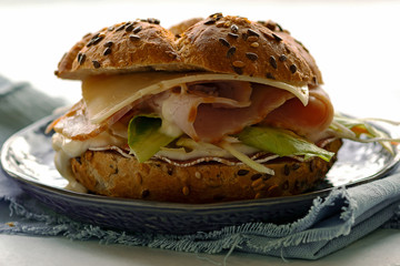 Healthy kaiser roll sandwich with ham, cheese and salad leaf