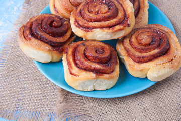 cinnamon buns on the wooden background