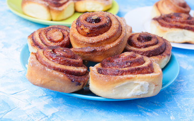 cinnamon buns on the wooden background