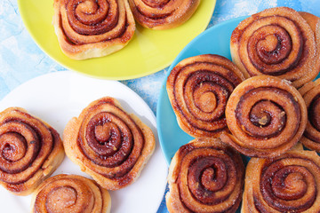 cinnamon buns on the wooden background