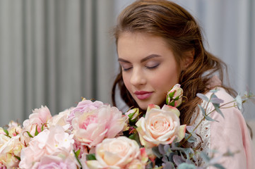 Attractive woman with bouquet of hundreds of flowers is spending time at home.
