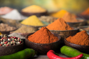 Assortment of spices in wooden bowl background