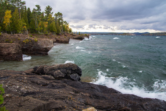 Marquette Michigan Waterfront. Waves crash on the seaside cliffs of Lake Superior at Presque Isle Park in downtown Marquette, Michigan. 