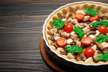 Traditional quiche tart in baking form with filling