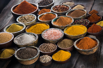 Obraz na płótnie Canvas Variety of spices and herbs on kitchen table